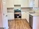 Well-equipped kitchen with granite countertops, stainless steel appliances, and white cabinets at 4411 Ward Bluff Ct, Ellenwood, GA 30294
