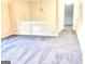Spacious living room with plush gray carpeting and a white railing at 4411 Ward Bluff Ct, Ellenwood, GA 30294