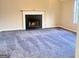 Open living room showcasing a fireplace and gray carpeting at 4411 Ward Bluff Ct, Ellenwood, GA 30294
