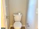 Close-up of a standard white toilet with a roll of toilet paper in a small bathroom at 4411 Ward Bluff Ct, Ellenwood, GA 30294