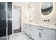 Luxurious bathroom featuring double vanity, marble floors, and walk-in shower with black accents at 115 Thome, Alpharetta, GA 30022