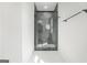 Modern bathroom with glass enclosed shower, black hardware, and white tile floors at 115 Thome, Alpharetta, GA 30022