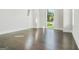 Spacious bedroom with hardwood floors and large windows showcasing the view at 115 Thome, Alpharetta, GA 30022