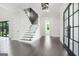 Bright foyer with hardwood floors, a staircase with glass railing, and modern fixtures at 115 Thome, Alpharetta, GA 30022