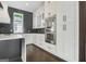 Modern kitchen with stainless steel appliances, custom cabinets, and herringbone backsplash at 115 Thome, Alpharetta, GA 30022