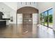 Open-concept living area boasts a fireplace, wall of built-ins, and access to the outdoors at 115 Thome, Alpharetta, GA 30022