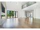 Open-concept layout with hardwood floors, large windows, and access to outdoor space at 115 Thome, Alpharetta, GA 30022