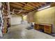Unfinished basement with open ceiling, concrete floor, and vintage wooden workbench and sink at 3452 Monica Sw Ln, Conyers, GA 30094