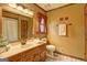 Bathroom features a classic vanity, floral wallpaper and tile flooring at 3452 Monica Sw Ln, Conyers, GA 30094