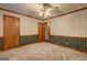 Bedroom with wallpaper, green trim and wainscotting at 3452 Monica Sw Ln, Conyers, GA 30094