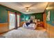 Spacious bedroom with a ceiling fan and sliding glass doors leading to a deck at 3452 Monica Sw Ln, Conyers, GA 30094