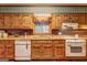 Charming kitchen featuring knotty pine cabinets, and vintage appliances and a view to the outdoors at 3452 Monica Sw Ln, Conyers, GA 30094