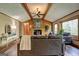 Inviting living room featuring wood beams, stone fireplace, and cozy seating arrangement at 3452 Monica Sw Ln, Conyers, GA 30094