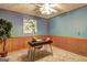 Office featuring a desk, wood paneling, and blue wall coloring at 3452 Monica Sw Ln, Conyers, GA 30094