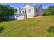 Exterior view of home showing a deck with stairs and large lot with mature landscaping at 221 Ashley Trace Dr, Locust Grove, GA 30248