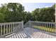 View from spacious deck overlooking lush green yard with mature trees and abundant sunlight at 221 Ashley Trace Dr, Locust Grove, GA 30248