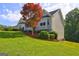 Two story home on a gently sloping lot with manicured lawn and mature landscaping at 221 Ashley Trace Dr, Locust Grove, GA 30248