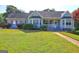 Charming home featuring a well-maintained lawn, lovely shrubs, and attractive curb appeal at 221 Ashley Trace Dr, Locust Grove, GA 30248