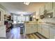 Spacious kitchen with wooden floors and white countertops with bar seating looking into dining space at 221 Ashley Trace Dr, Locust Grove, GA 30248