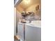 Laundry room with washer and dryer, shelf for supplies, and a bright light at 221 Ashley Trace Dr, Locust Grove, GA 30248