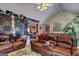 Spacious living room showcasing a large leather sofa, hardwood floors and unique decor at 221 Ashley Trace Dr, Locust Grove, GA 30248