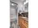 Bathroom with wood cabinets, granite countertop, and updated shower at 1026 Ponderosa Park Dr, Forest Park, GA 30297