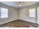 This bright bedroom features hardwood floors, base molding, and windows for natural light at 1026 Ponderosa Park Dr, Forest Park, GA 30297