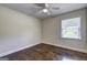 This bedroom features a ceiling fan and a window letting in plenty of natural light, highlighting the wood floor at 1026 Ponderosa Park Dr, Forest Park, GA 30297