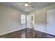 Bedroom with hardwood floors and a ceiling fan, with a view into the adjoining bathroom at 1026 Ponderosa Park Dr, Forest Park, GA 30297