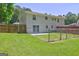 Large fenced in backyard and white brick exterior of home and sliding glass door at 1026 Ponderosa Park Dr, Forest Park, GA 30297