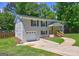 View of the charming white brick home showing the attached garage and pathway to the front door at 1026 Ponderosa Park Dr, Forest Park, GA 30297