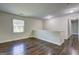 Hallway boasts gleaming wood floors and ample natural light from the window and lighting fixtures at 1026 Ponderosa Park Dr, Forest Park, GA 30297