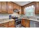 The kitchen includes wooden cabinets, stainless steel appliances, and a bright window at 1026 Ponderosa Park Dr, Forest Park, GA 30297