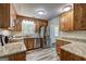 Kitchen features wooden cabinets, granite countertops, and stainless steel appliances for a modern touch at 1026 Ponderosa Park Dr, Forest Park, GA 30297