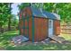 Outdoor shed with barn roof and double doors for ample storage in the backyard at 1026 Ponderosa Park Dr, Forest Park, GA 30297