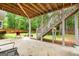 Backyard featuring a stone patio, steps leading to lawn, and wooded backdrop at 1596 Fearn Ne Cir, Brookhaven, GA 30319