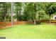 Lush green backyard enclosed by a wood fence and mature trees, offering privacy at 1596 Fearn Ne Cir, Brookhaven, GA 30319