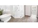 Clean, modern bathroom with a soaking tub, glass shower, and wood look ceramic tile at 1596 Fearn Ne Cir, Brookhaven, GA 30319