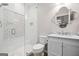 Modern bathroom with marble-look vanity, tiled shower, and decorative mirror at 1596 Fearn Ne Cir, Brookhaven, GA 30319