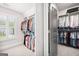 Walk-in closet features custom shelving and ample storage space for an organized wardrobe at 1596 Fearn Ne Cir, Brookhaven, GA 30319