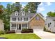 Charming two-story home featuring stone accents, a welcoming front porch and a manicured lawn at 1596 Fearn Ne Cir, Brookhaven, GA 30319