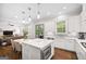 Modern kitchen with white cabinets, an island with seating, and stainless steel appliances at 1596 Fearn Ne Cir, Brookhaven, GA 30319