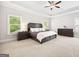 Spacious primary bedroom with tray ceiling, carpet, and windows with bright, natural light at 1596 Fearn Ne Cir, Brookhaven, GA 30319