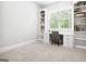 Bright office space features built-in shelving and a window overlooking the outdoors at 1596 Fearn Ne Cir, Brookhaven, GA 30319