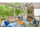 Covered back porch with stone fireplace and outdoor seating at 1596 Fearn Ne Cir, Brookhaven, GA 30319