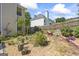 Landscaped backyard featuring lush greenery, potted plants, and a decorative fence at 3842 Monticello St, Douglasville, GA 30135