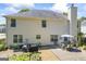 Rear exterior featuring a stone patio, mature landscaping, and outdoor seating area at 3842 Monticello St, Douglasville, GA 30135