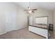 A bright bedroom features a ceiling fan and neutral carpet, complemented by natural light from the windows at 3842 Monticello St, Douglasville, GA 30135