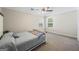 Cozy bedroom with a comfortable bed, neutral carpeting, ceiling fan, and natural light from two windows at 3842 Monticello St, Douglasville, GA 30135