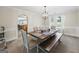 Traditional dining room featuring a wooden table, bench seating, and a pendant light fixture at 3842 Monticello St, Douglasville, GA 30135